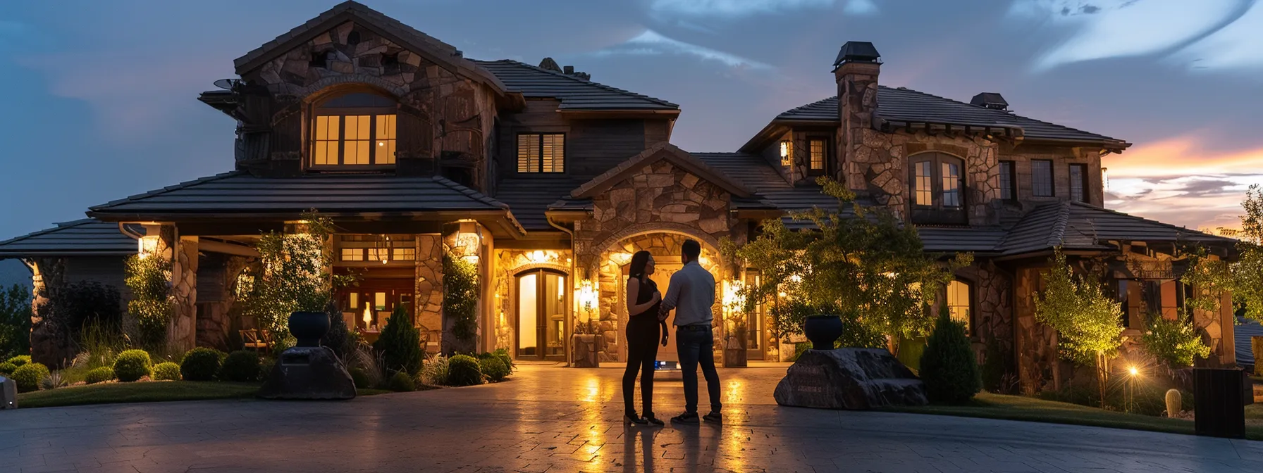 a couple standing in front of a luxurious st. george home, discussing terms with a real estate agent from the oaks real estate team. a couple standing in front of a luxurious st. george home, discussing terms with a real estate agent from the oaks real estate team.