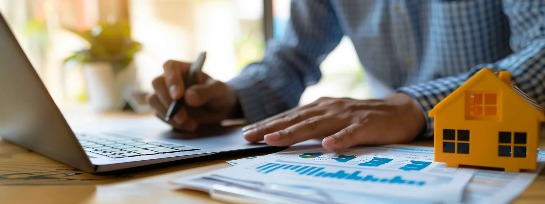 a homeowner sitting at a modern desk with a laptop, calculator, and paperwork, strategically planning the effective utilization of a home equity loan in st. george.