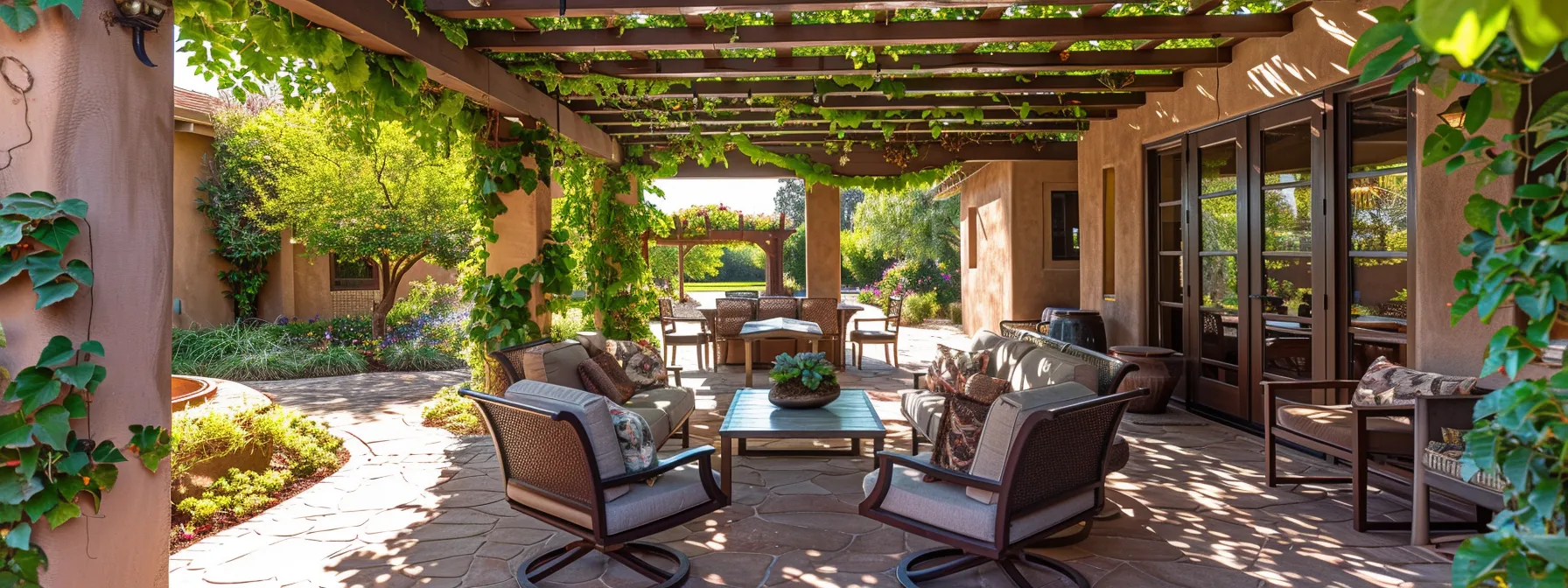 a cozy outdoor patio with a pergola covered in lush green vines, comfortable seating, and strategically placed shade elements in a st. george home.