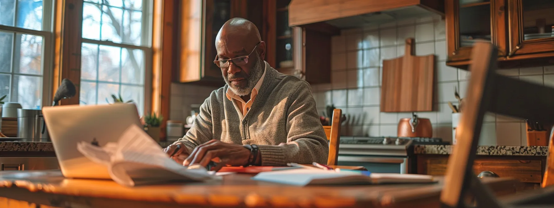 a homeowner carefully reviewing different home warranty plans while sitting at a cozy kitchen table, surrounded by paperwork and a laptop.